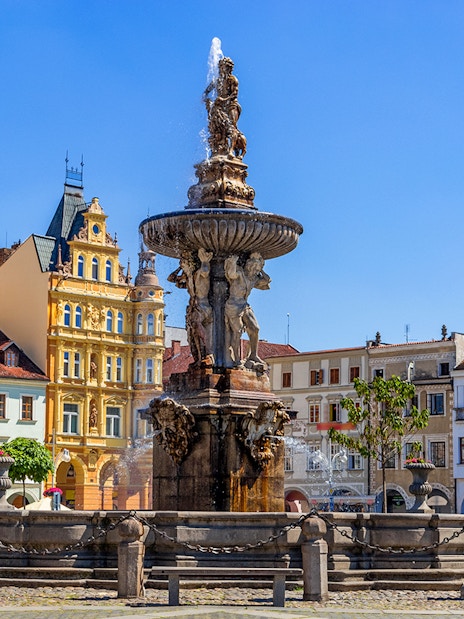 Samson fighting lion fountain and bell tower in main square, Ceske Budejovice.