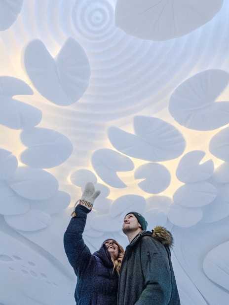 Guests admiring ice sculptures inside Arctic SnowHotel.