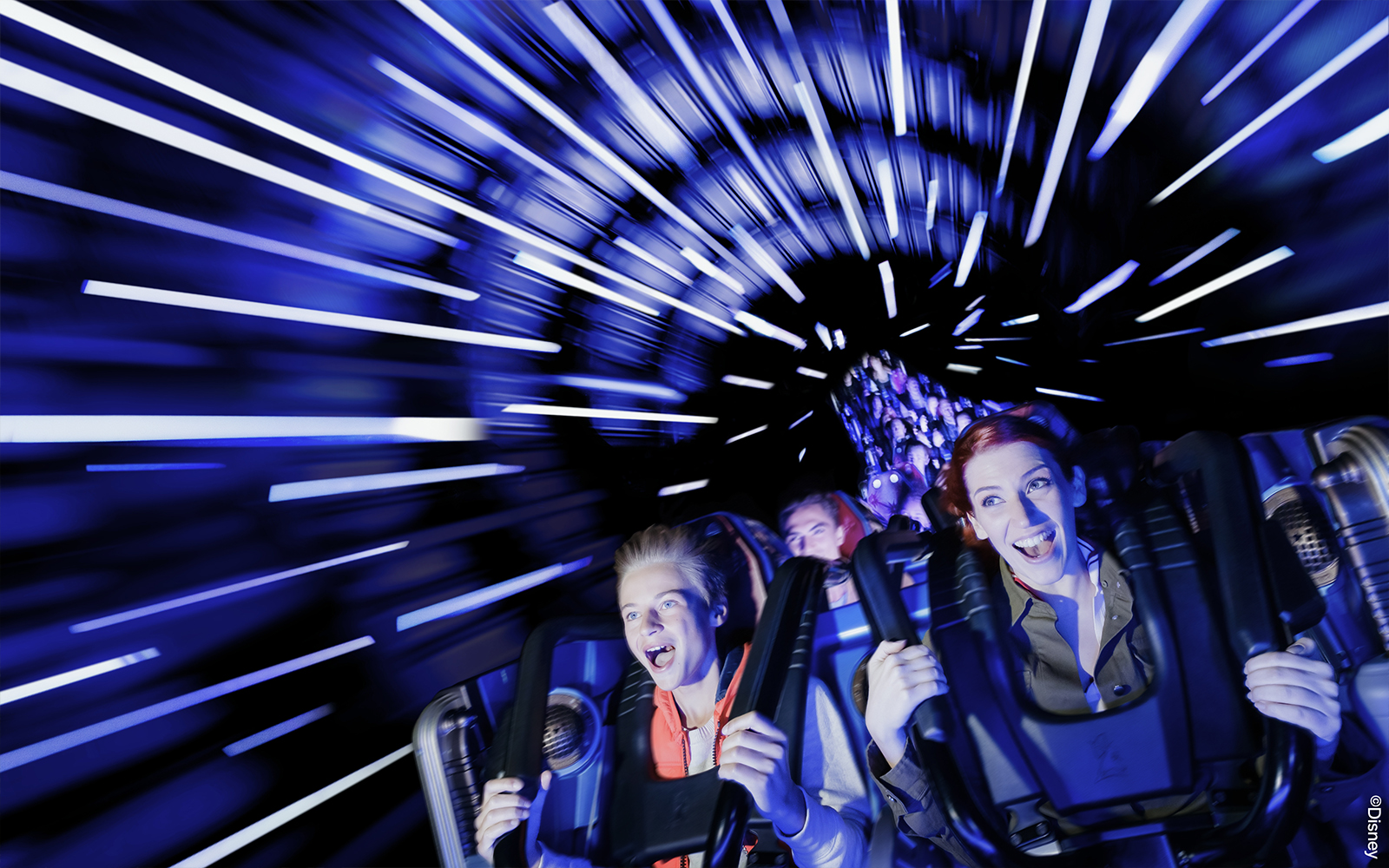 People enjoying the Hyperspace Mountain ride at Disneyland Paris.