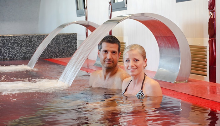 Couple relaxing in a thermal pool at Rudas Thermal Spa, Budapest.