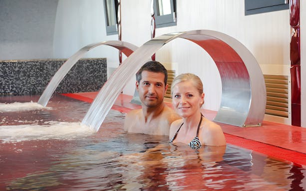 Couple relaxing in the pool at Rudas Thermal Spa, Budapest.