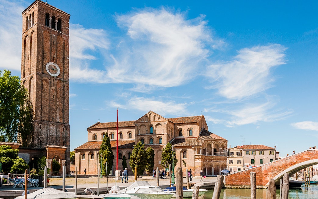 Santi Maria e Donato Basilica with bell tower in Murano, Italy, viewed from canal.