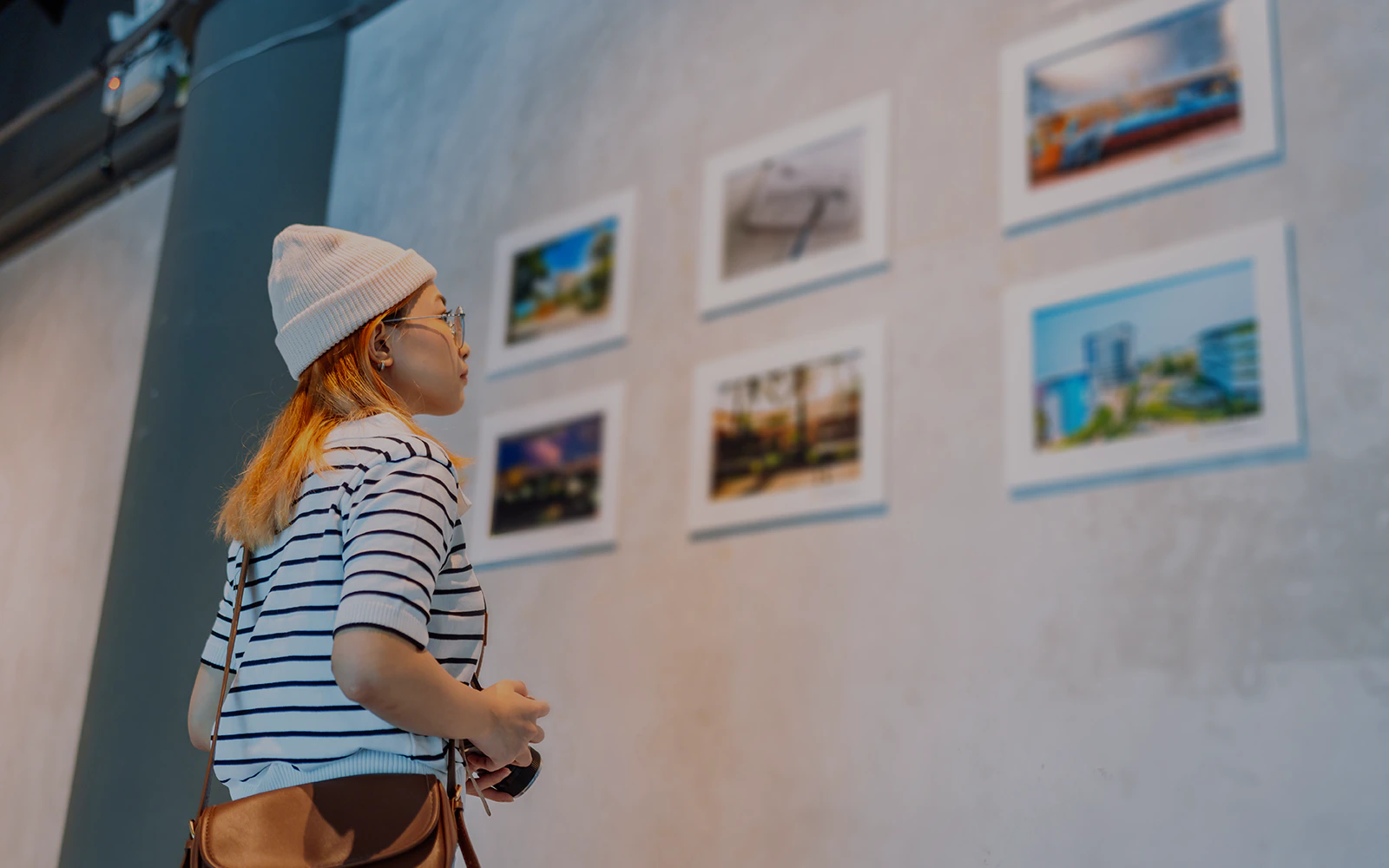 Visitor observing photography exhibit in museum.