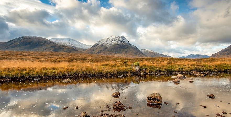 Glencoe landscape with mountains and reflective water, part of Edinburgh tour.