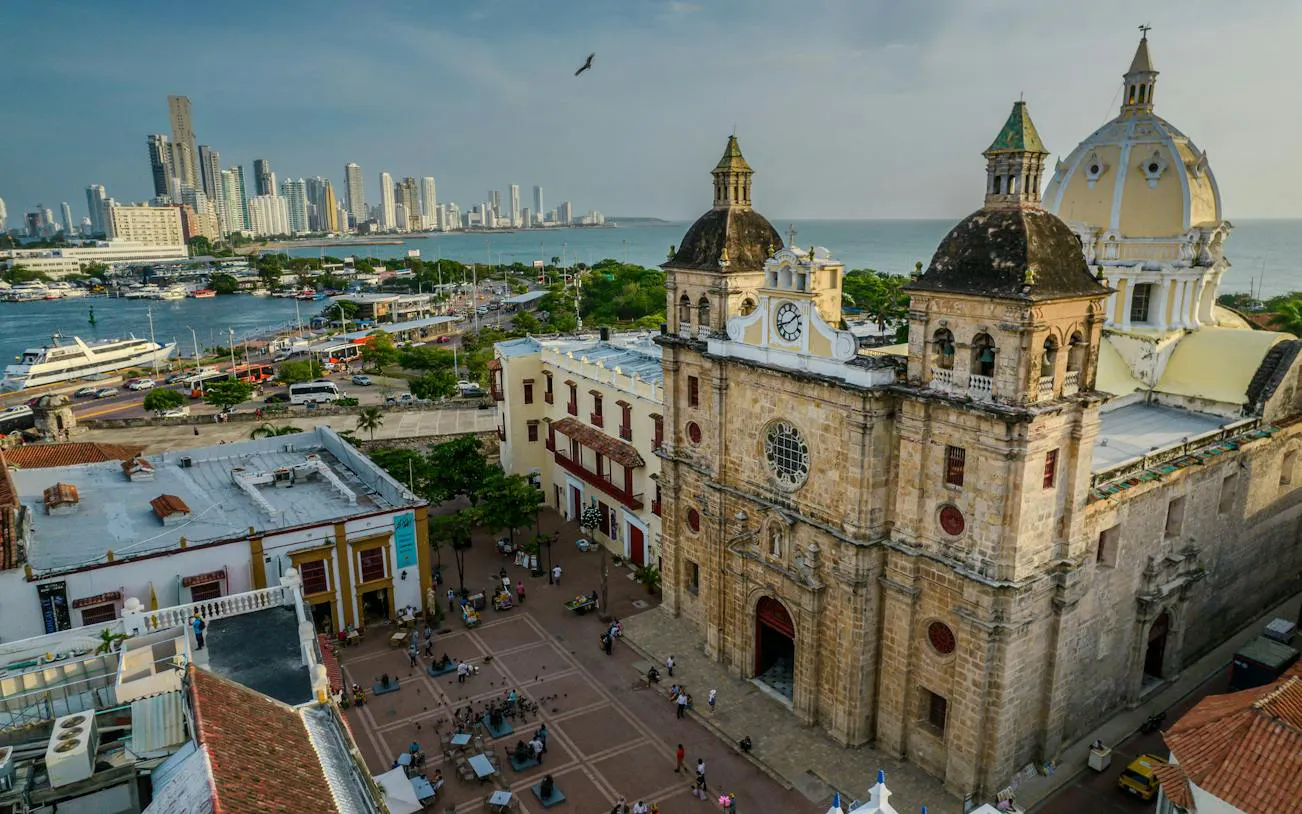 Cartagena cityscape with historic cathedral and modern skyline in the background.
