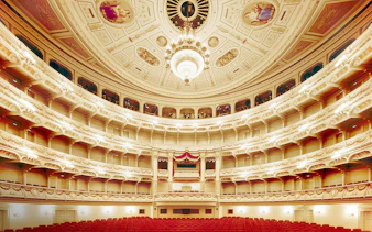 Semperoper Dresden auditorium with ornate ceiling and red seating.