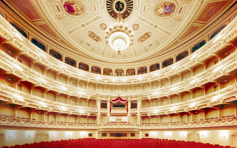 Semperoper Dresden auditorium with ornate ceiling and red seating.