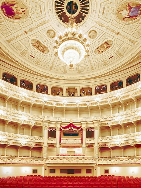 Semperoper Dresden auditorium with ornate ceiling and red seating.