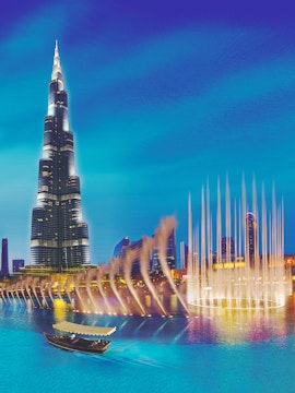 Burj Khalifa and Dubai Fountain with boat on water, Dubai, UAE.