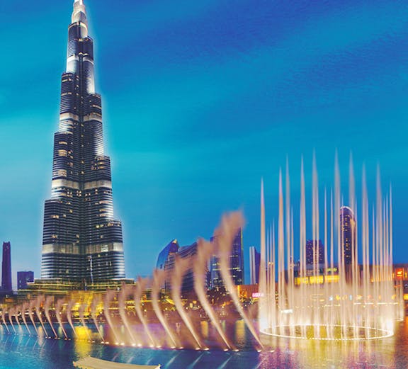 Burj Khalifa and Dubai Fountain with boat on water, Dubai, UAE.