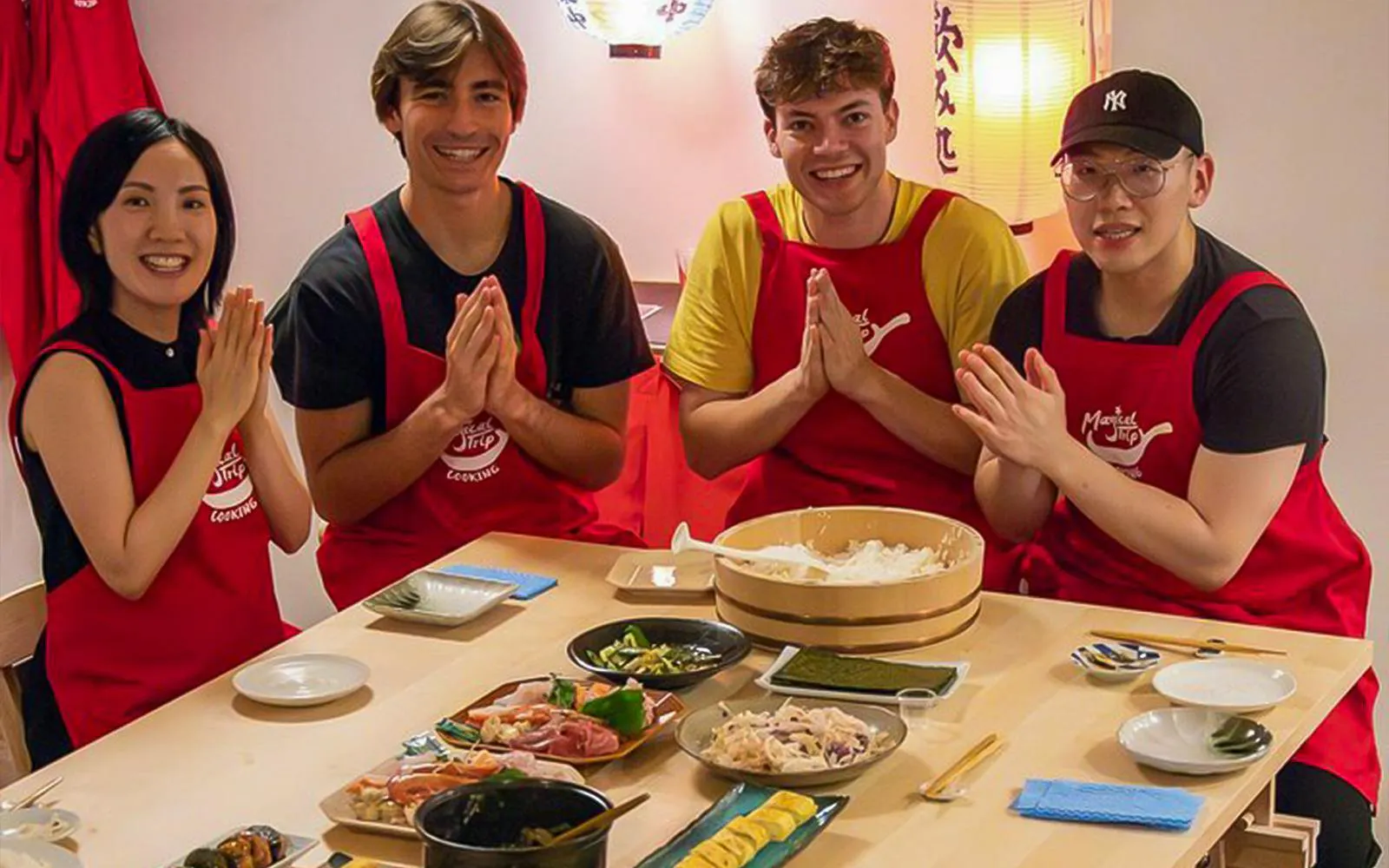 Participants in a Tokyo izakaya-style cooking class preparing traditional dishes.