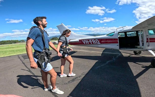Skydivers walking towards plane for tandem skydive in Shellharbour, Sydney.