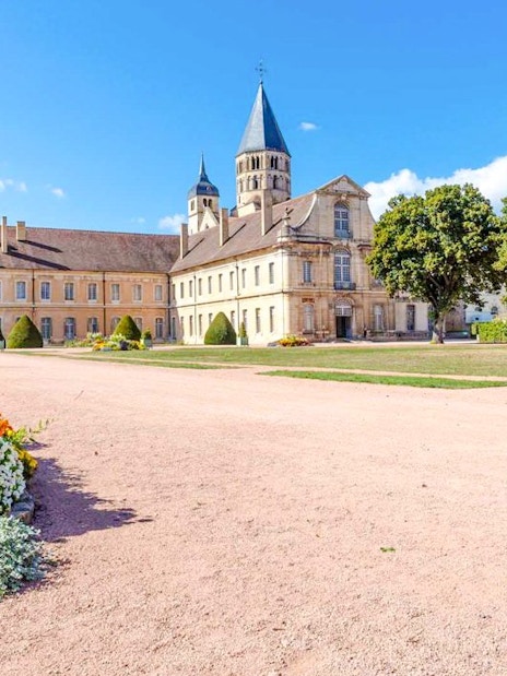 Cluny Abbey courtyard with colorful flowers, Lyon, France.