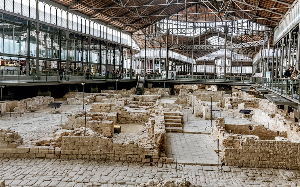 Tourists viewing ancient ruins at El Born Cultural Center in Barcelona.