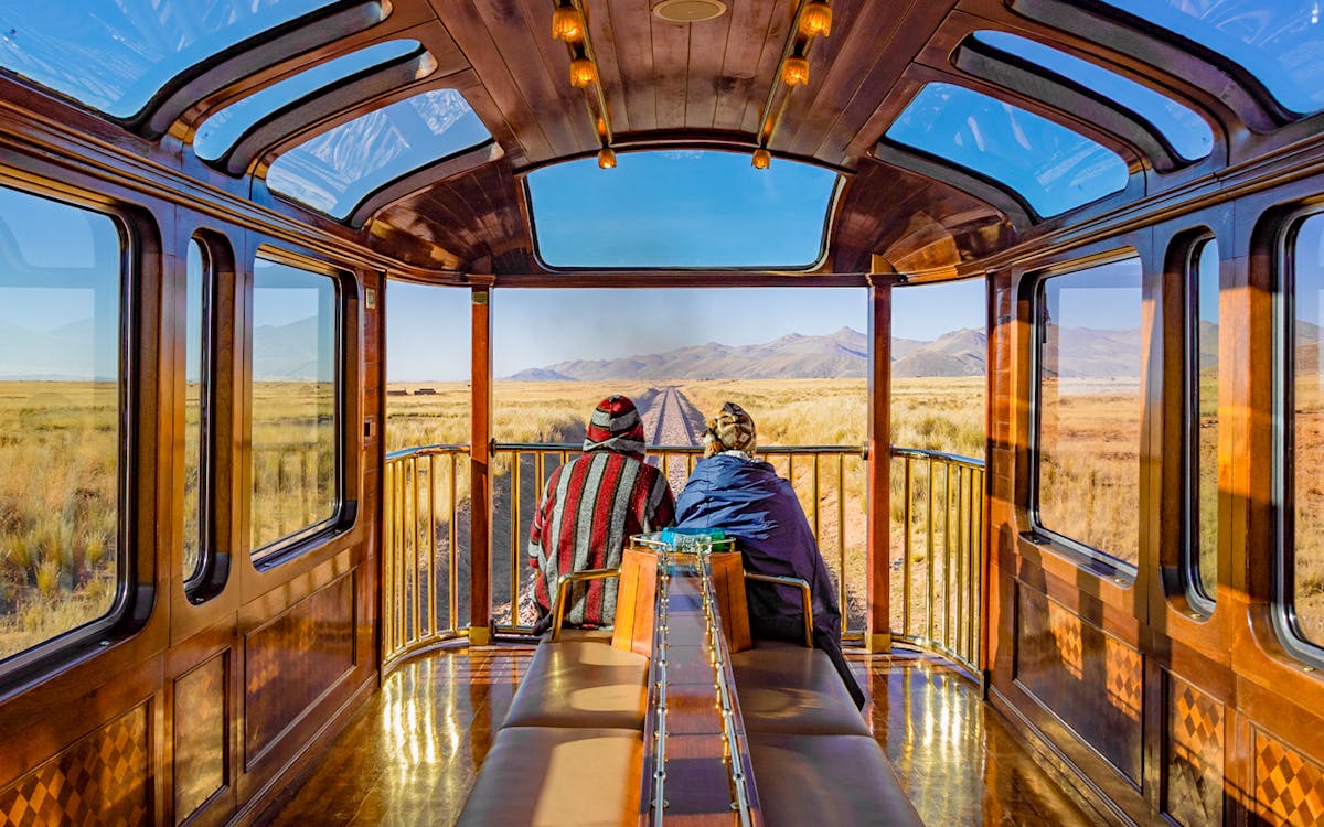 couple Enjoying the observation deck of the PeruRail Titicaca Train
