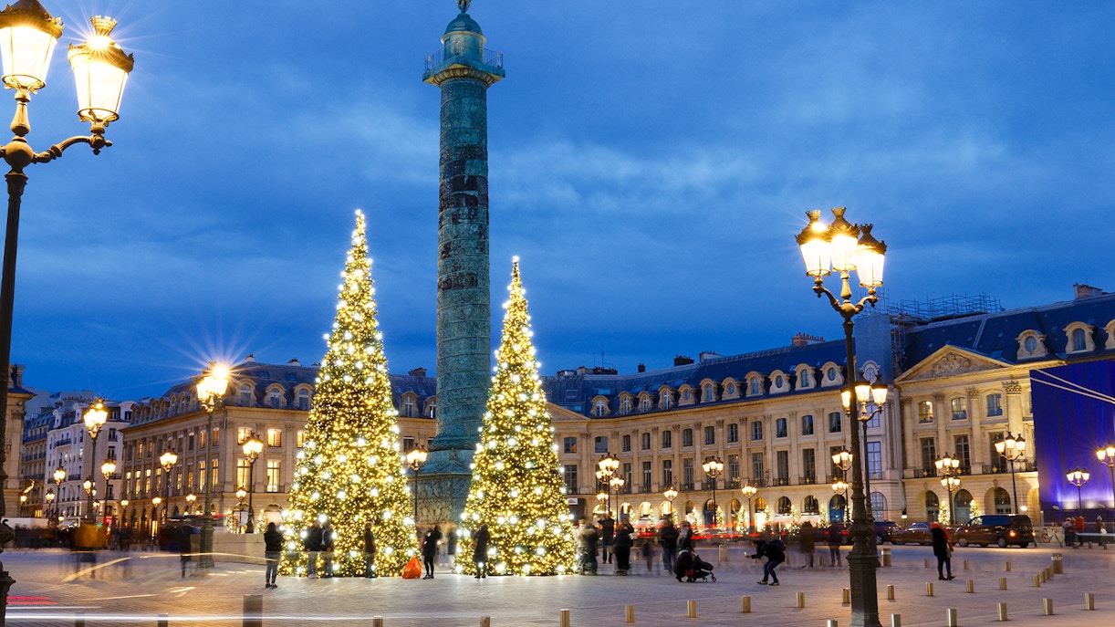 Christmas lights and decorated trees at Place Vendôme, Paris during evening.