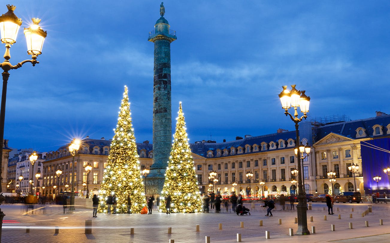 Christmas lights and decorated trees at Place Vendôme, Paris during evening.