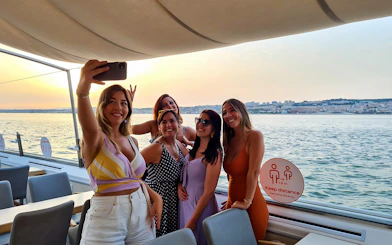 Group enjoying a sunset cruise on the Tagus River in Lisbon.