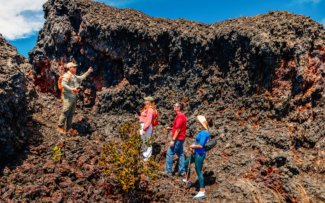 Guests exploring volcanic terrain on Hawaii adventure tour.