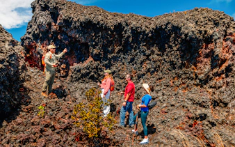 Guests exploring volcanic terrain on Hawaii adventure tour.