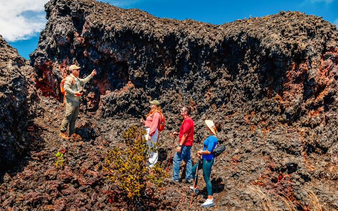 Guests exploring volcanic terrain on Hawaii adventure tour.