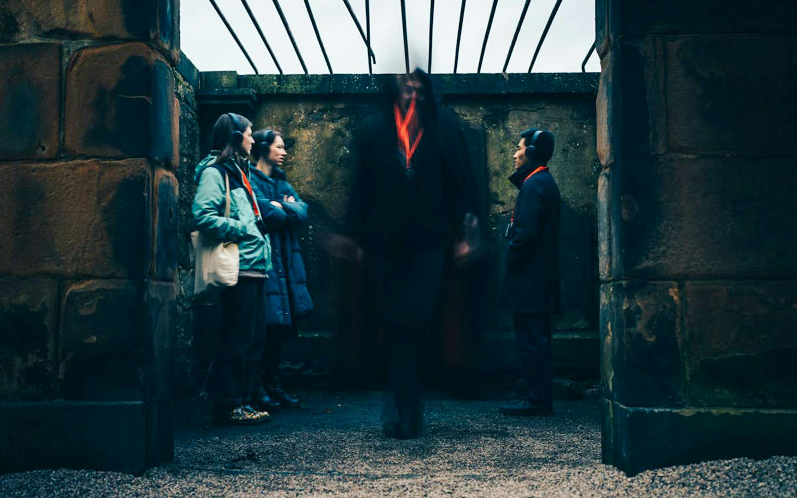 Guests on the Doomed, Dead and Buried tour in Edinburgh standing in a historic stone structure.
