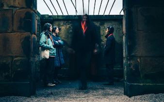 Guests on the Doomed, Dead and Buried tour in Edinburgh standing in a historic stone structure.