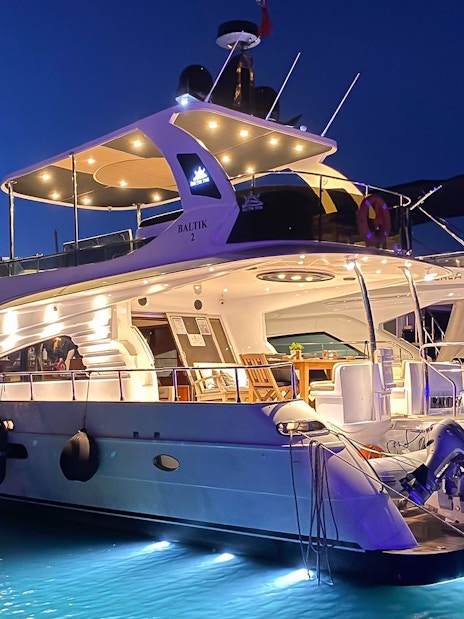 Luxury yacht illuminated at night on the Bosphorus, Istanbul.