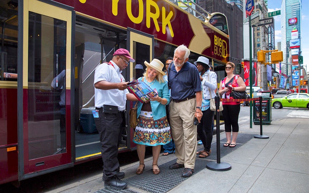Tourists boarding Big Bus HOHO Tour at Times Square, New York.