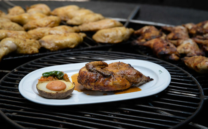 Grilled chicken and potato served on a plate at Timanfaya National Park's volcano dinner.