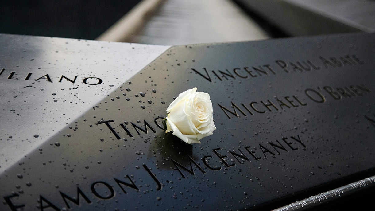 White rose on engraved names at 9/11 Memorial, New York City.