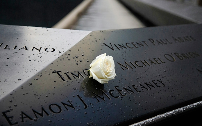 White rose on engraved names at 9/11 Memorial, New York City.