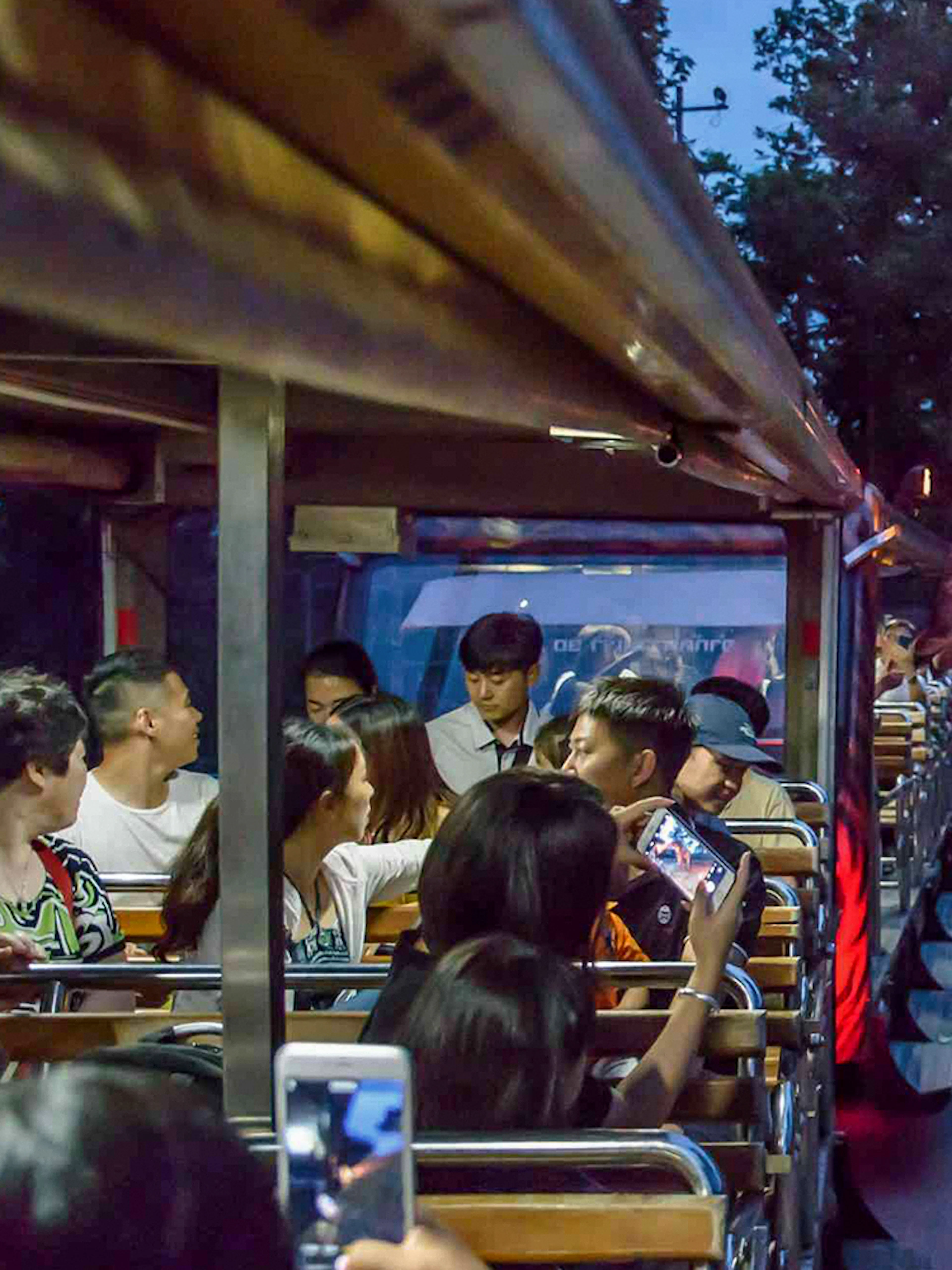 People feeding a giraffe from a tram at Night Safari Park, Chiang Mai.