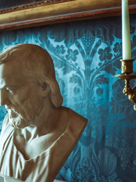 Bust sculpture and ornate candelabras in the Royal Palace of Caserta.