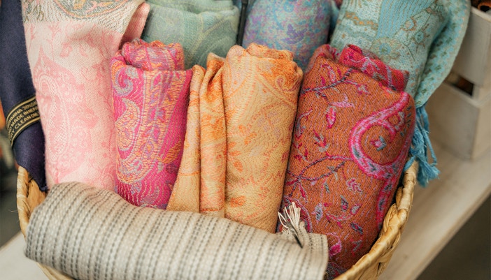 Colorful woven scarves in a basket