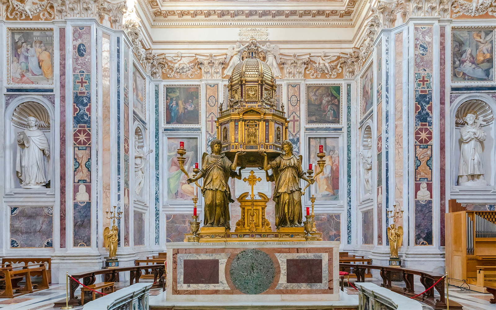 Basilica Santa Maria Maggiore interior with ornate altar and statues in Rome.