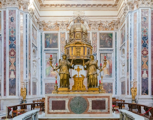 Basilica Santa Maria Maggiore interior with ornate altar and statues in Rome.