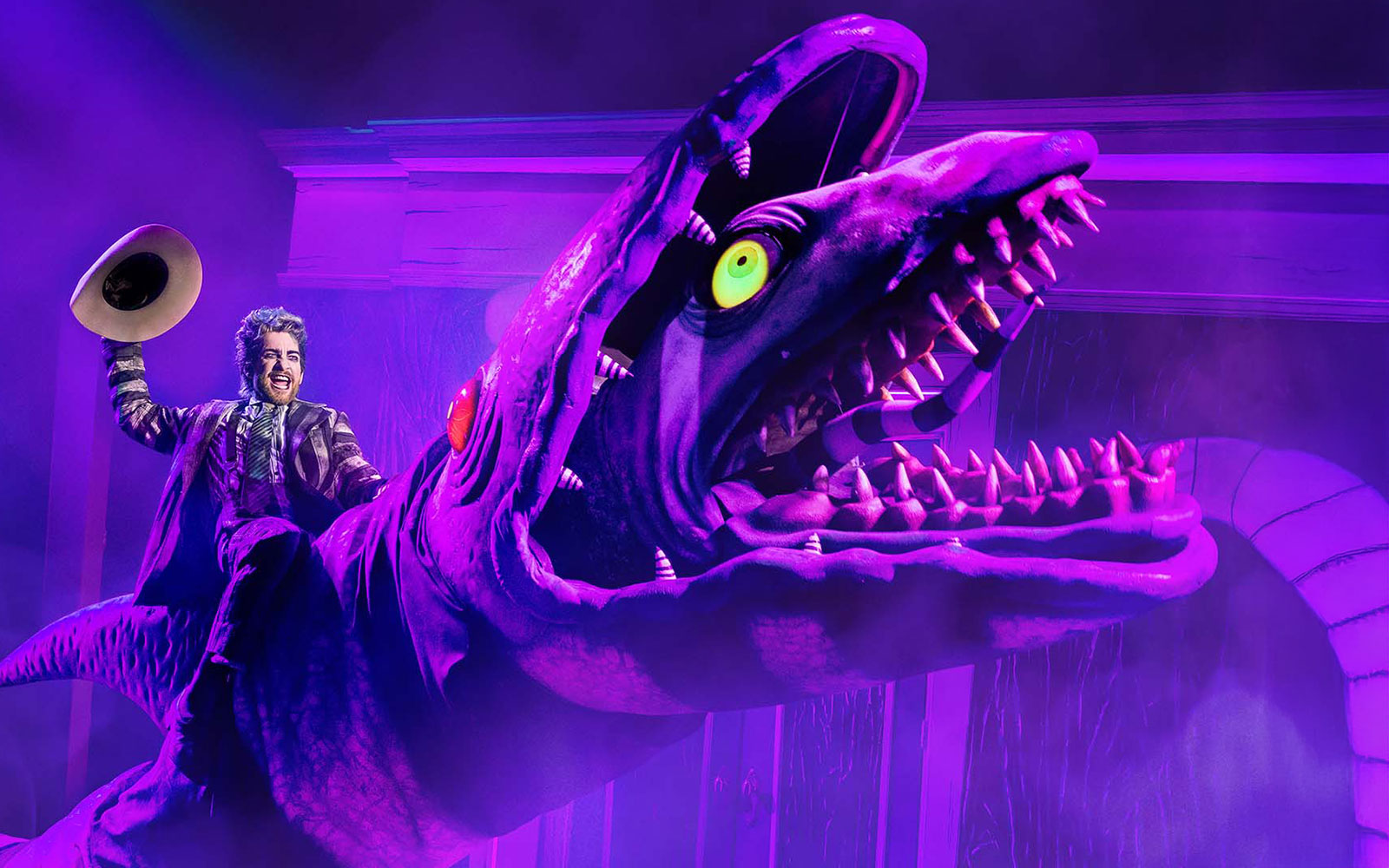 Performer riding a giant creature during Beetlejuice show in Brisbane.