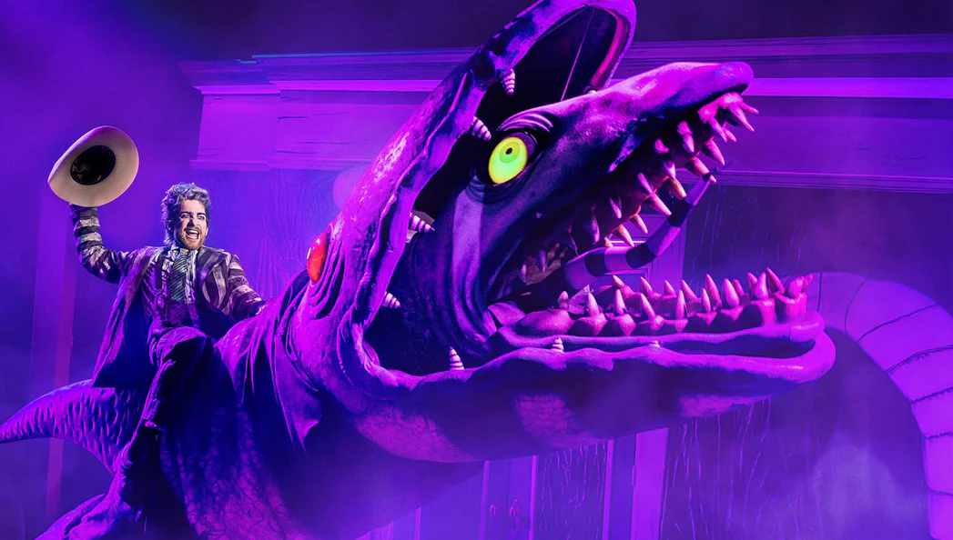 Performer riding a giant creature during Beetlejuice show in Brisbane.