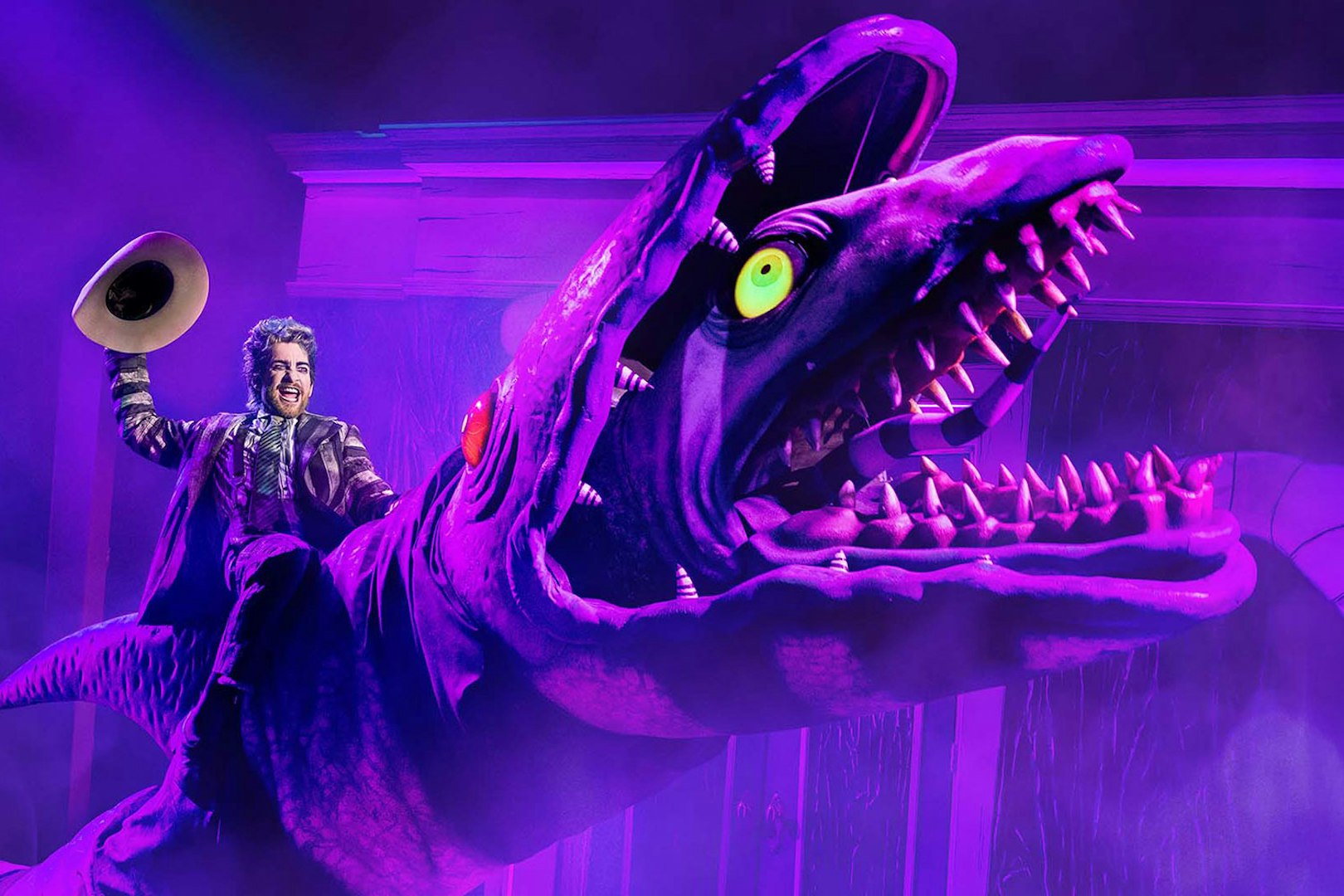 Performer riding a giant creature during Beetlejuice show in Brisbane.