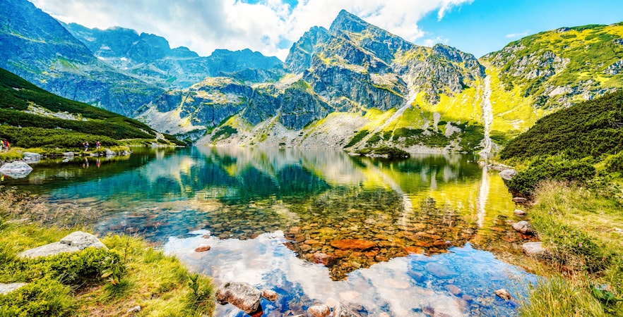 Mountain lake with clear water reflecting peaks in Tatra National Park, Poland.