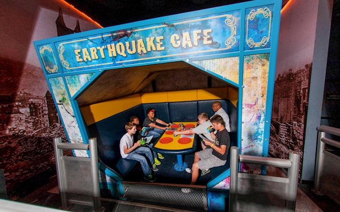 Visitors experiencing the Earthquake Cafe at Wonderworks.