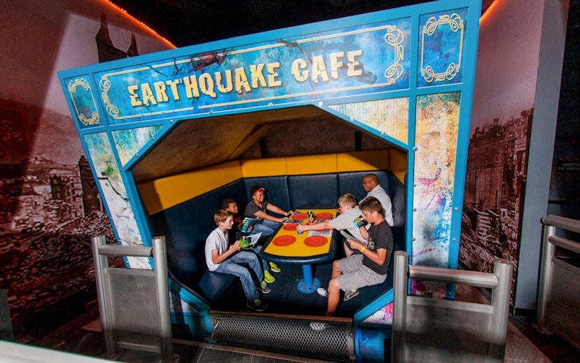 Visitors experiencing the Earthquake Cafe at Wonderworks.