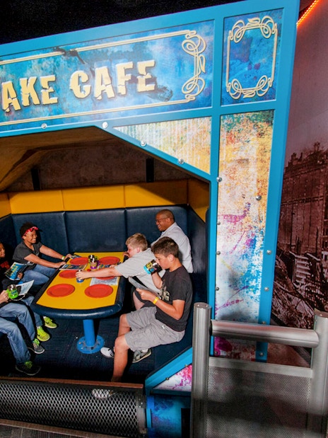 Visitors experiencing the Earthquake Cafe at Wonderworks.
