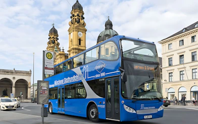 Double-decker tour bus near Theatinerkirche in Munich city center.