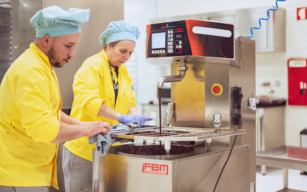 Chocolate makers using equipment at The Chocolate Story Museum.