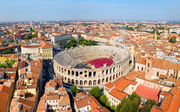 Aerial view of the Verona Arena surrounded by historic buildings in Verona, Italy.