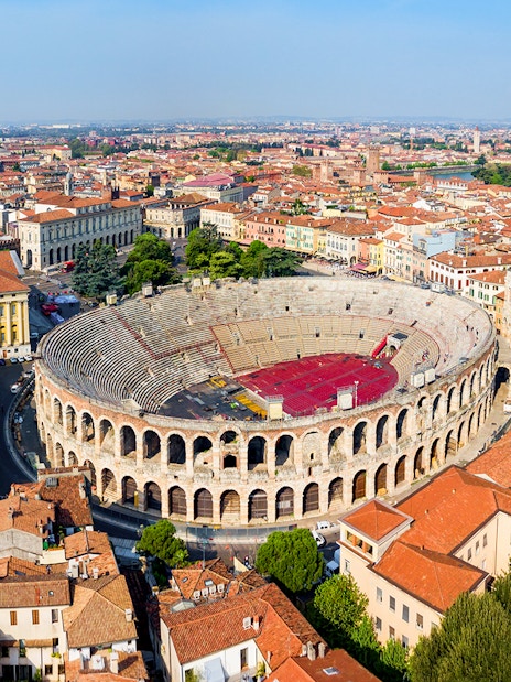 Aerial view of the Verona Arena surrounded by historic buildings in Verona, Italy.