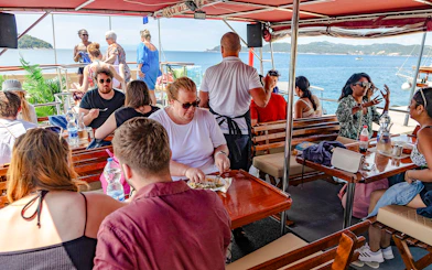 Guests dining on deck during Elaphite Island Cruise, Dubrovnik.
