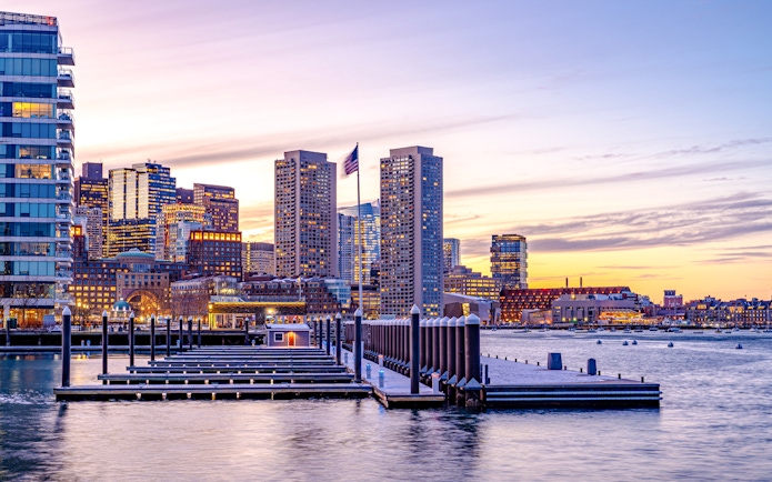 Boston downtown skyscrapers at sunset viewed from the waterfront.